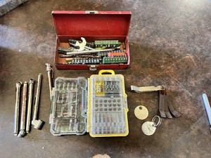 Lot of Hand Tool Accessories including Masterforce Screwdriver Bit Set, 32-Piece Bit Set in Yellow Case, Red Metal Toolbox with Assorted Screwdriver Bits, Tire Pressure Gauges, Feeler Gauge Set, and Misc Tokens