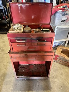 Metal Tool Chest with Tools including screwdrivers, hammers, saws, measuring tapes, and brushes