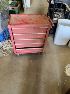 Craftsman Red Tool Chest with Tools such as screwdrivers, levels, and clamps