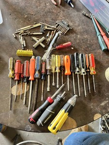 Various brand screwdrivers, bits, and hand tools