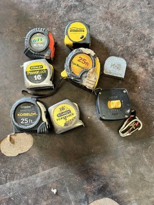 Various Tape Measures Including Stanley PowerLock, Komelon Gripper, and American Family Insurance