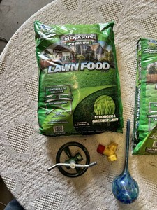 Menards Lawn Food and Garden Accessories including Lawn Sprinkler, Hose Fittings, and Glass Watering Globe