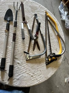 Garden hand tools including trowel, garden fork, hedge shears, pruning shears, and bow saws Set