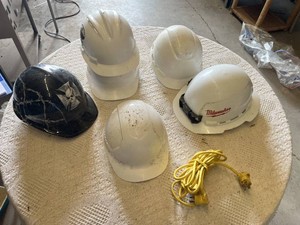 Hard hats including Milwaukee Model, White Hard Hats, Black Hard Hat with Skull Design, and Extension Cord