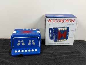 This Schylling blue childrens accordion features 7 key buttons and two bass buttons for young musicians