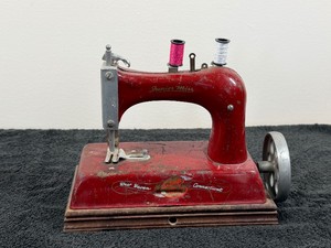 vintage Junior Miss Deluxe Model toy sewing machine manufactured around the 1940s to 1950s.