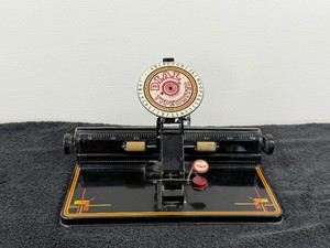 vintage Louis Marx and Company tin dial typewriter toy, likely manufactured between the late 1920s and 1930s
