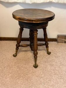 antique Victorian swivel piano stool with claw and ball feet from the late 19th to early 20th century