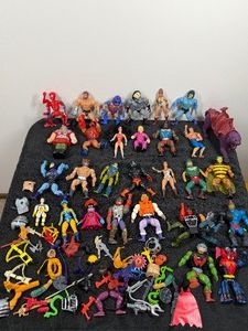 vintage 1980s Masters of the Universe action figures, featuring characters like Skeletor, He-Man, Zodac, Ram Man, Fisto and various accessories