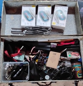 Metal suitcase with legs full of misc