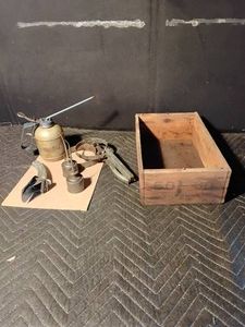 Wood box os 3 oil cans, oil filter wrenches and a metal oil can spout