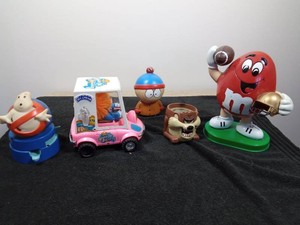 Cabbage Patch ice cream truck, Ghost Busters gum ball machine, MM character, South Park dude and Taz candle