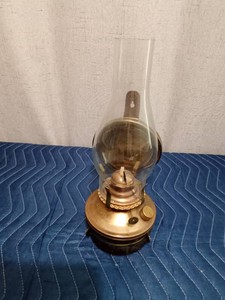 Vintage brass toned wall mounted oil lamp with reflective back shiels