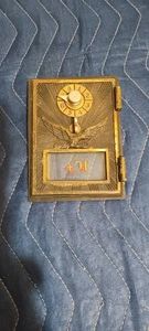 Antique brass US Post Office box door with combination lock