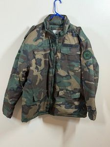 U.S. Military M-1965 field jacket in a classic M81 woodland camouflage pattern,