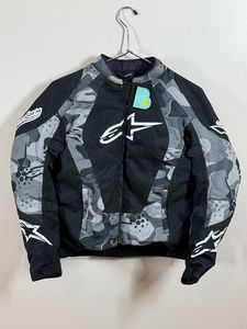 Alpinestars Stella Sniper Air Flo motorcycle jacket, featuring a distinct black, white, and grey camouflage design - Womens Size Medium