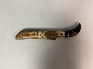 Gurkha kukri knife with an ornate, curved blade and a decorated handle featuring intricate patterns 11.5 Overall