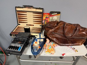 Grandpas Attic Finds Flashlights, Backgammon Set (missing dice), Vintage Leather Bag, Cassette Player, Vegas Fan, Japanese Doll (needs repair)