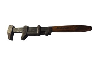 Vintage Coes Wrench Co. adjustable monkey wrench featuring a distinctive wooden handle.Similar antique models, often from the late 19th or early 20th century