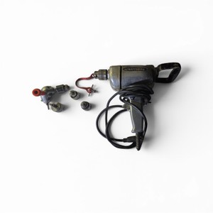 vintage Craftsman corded electric drill, possibly a 12-inch model, featuring a metal housing and black cord.The set includes the drill along with several different drill chucks and a red chuck key.These industrial-rated tools from the 1960s or earlier ar