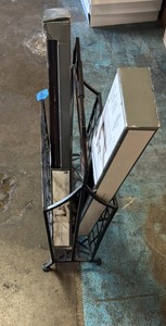 Metal newspaper holder and wooden picture ledges