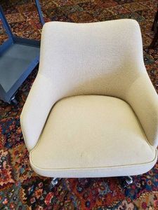 Highly collectable cushioned office chair on rollers