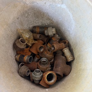 Lot of Assorted Pipe Fittings and Plumbing Connectors in Plastic Bucket