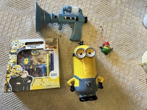 Despicable Me Themed Lot Minion Piggy Bank, Light-up Fart Gun, Dressed Minion Figurine, and Activity Pack