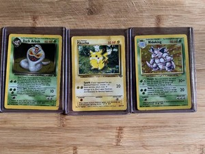 Lot of 3 Pokemon Trading Cards Featuring Dark Arbok HOLO, Pikachu, and Nidoking
