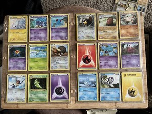 Lot of 18 Pokemon Trading Cards featuring multiple characters including Metapod, Swinub, Diglett, and others with various energy cards