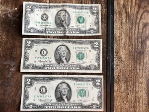 Three United States $2 bills Two are from the 1976 series, and one is from the 2009 series