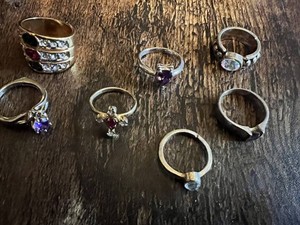 Vintage and costume ring collection including multi-stone band, solitaire rings, and gemstone accents