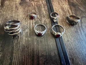 Rings with various designs including some with red stones and geometric patterns