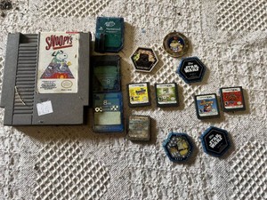 Old Nintendo, Nintendo DS, and PS2 video games, memory cards, and Star Wars collectible pieces including The Penguins Madagascar, Ben 10, and Mario Hoops 3-on-3.