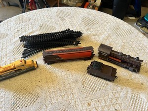 Model train set featuring locomotives and freight cars by Caterpillar and ATSF, plus tracks