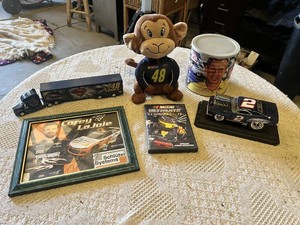 NASCAR Memorabilia Collection including Rusty Wallace Model Car, Corey LaJoie Autograph, NASCAR DVD, Monkey Plush, and Other Items