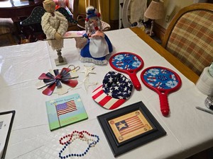 Patriotic Decor and Toy Lot Including Metal Stars, Dolls, and Paddle Games