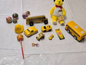 Yellow toy vehicle and accessory set including Parker Store Miniature Race Car, Burger King Crayola Crayon Box, and Assorted Toy Balls