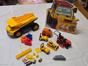 Toy Construction Vehicles and Accessories Lot including CAT Dump Truck, Orange Rescue Vehicle, and Big Bulldozer Book