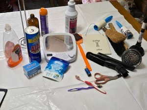 Various Cleaning and Household Items, Including UltraLuxe Detergent and Brushes