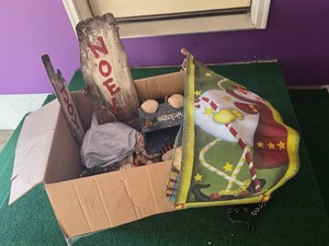 Box of Christmas Decorations including Welcome and Noel Signs, Snowman Themed Decorations, and Festive Flags