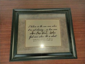 This framed artwork features a calligraphy print of a famous quote often attributed to inscriptions found in a concentration camp during World War II.