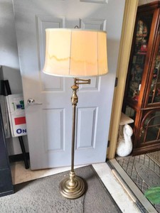 Vintage brass floor lamp appears to be a Underwriters Laboratories swing arm model featuring an ornate stem design