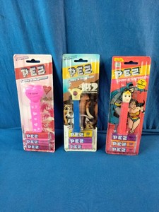 Three vintage, carded PEZ candy dispensers from different classic sets still sealed in their original blister packs