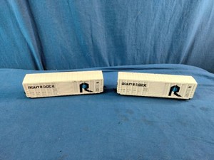 Two N scale or HO scale model railroad boxcars, specifically representing the Rock Island Route Rock scheme