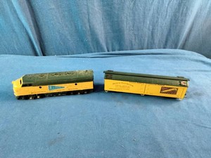 HO Scale models of a Chicago and North Western Railway F7 diesel locomotive and matching box car.