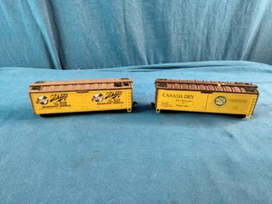 Athearn HO scale 40-foot wood refrigerator cars, likely vintage models featuring Schlitz Beer and Canada Dry Ginger Ale graphics.