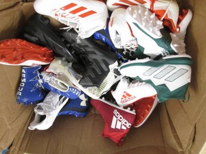 Assorted pairs of new football clea...