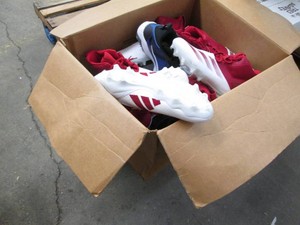 Assorted pairs of new football clea...