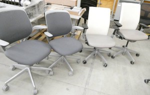 4 chairs - 2 are white and grey vinyl and 2 are grey fabric